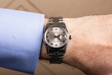 Rolex Datejust 36 Stainless Steel White & Gold Bezel Silver Roman Dial Watch 16234 man wearing the watch on his wrist